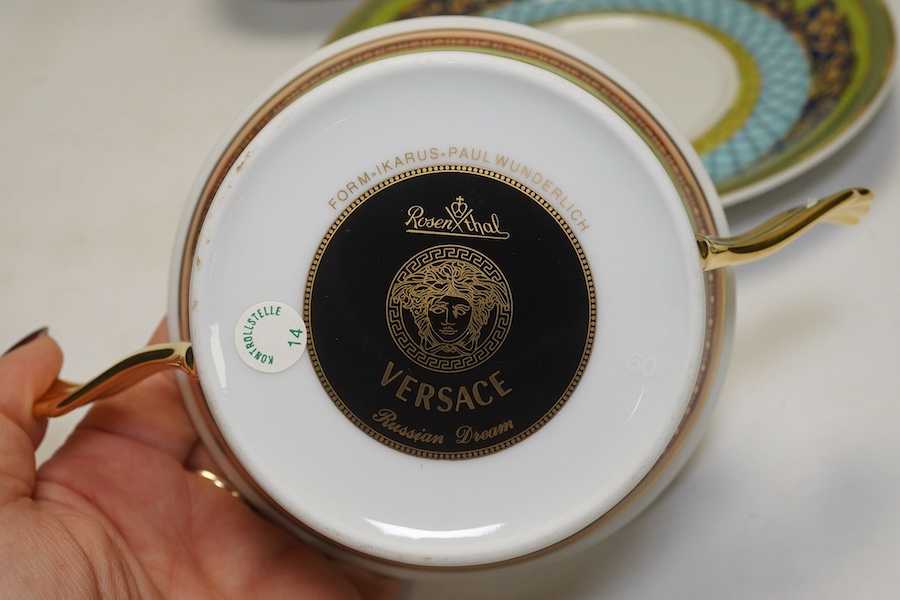 Six Rosenthal for Versace porcelain items; a boxed chocolate cup and saucer, four oblong serving dishes, longest 23cm, and a boxed miniature timepiece, 8.5cm high. Condition - good.